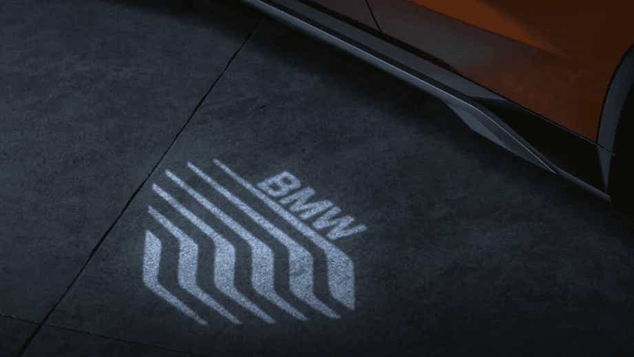 Illuminated door logo projection near a BMW X1