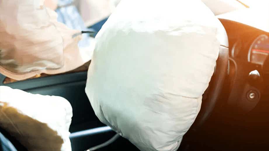 steering wheel and dashboard view of a BMW X5 with deployed airbags