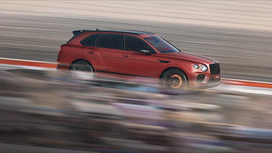 side profile of a Bentley Bentayga driving on a track