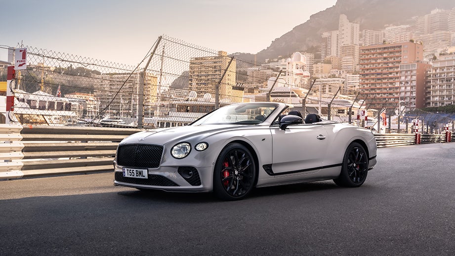 Front three-quarter view of a Bentley Continental convertible on a city racetrack