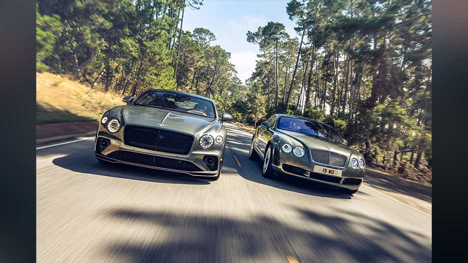 front view of a Bentley Continental on a road surrounded by trees