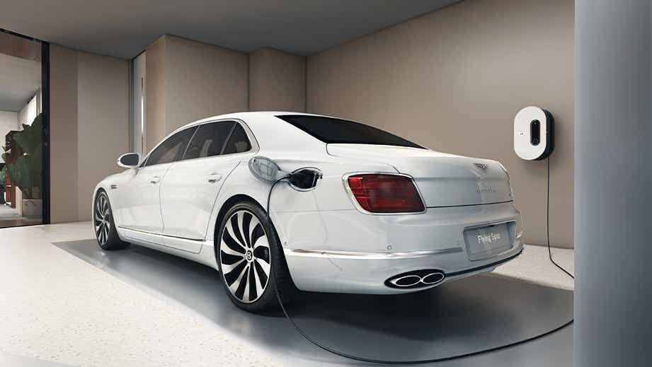 Rear three-quarter view of a Glacier White Solid Bentley Flying Spur