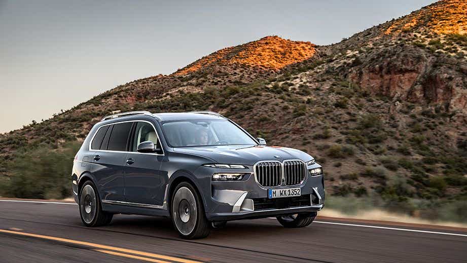 front three-quarter view of a BMW X7 driving on a road