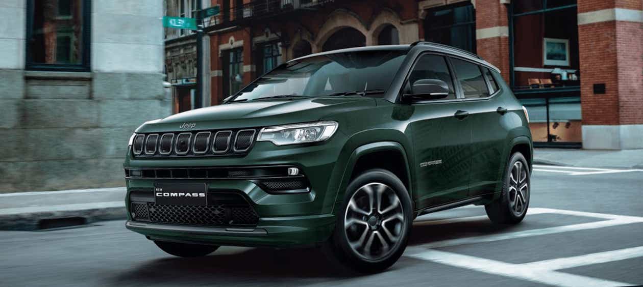 front three-quarter view of a Techno Metallic Green Jeep Compass