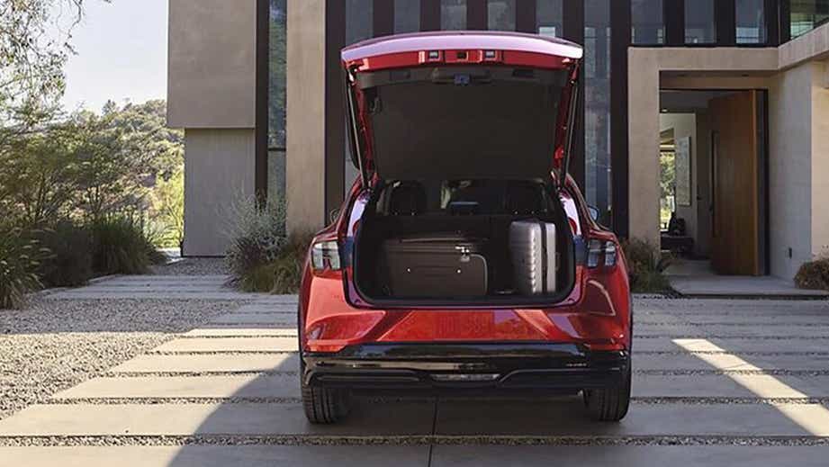 Rear view of a Eruption Green Metallic Ford Mach-E with open boot