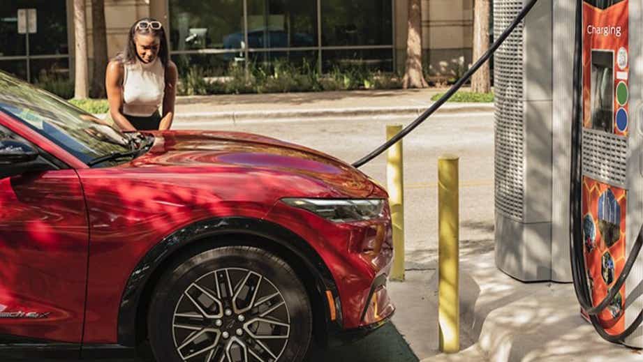 Front side view of a Ford Mach-E at a charging station