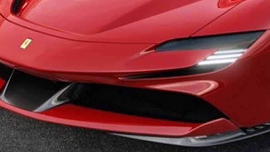 front headlight and grille of a Rosso Corsa Ferrari SF90 Stradale