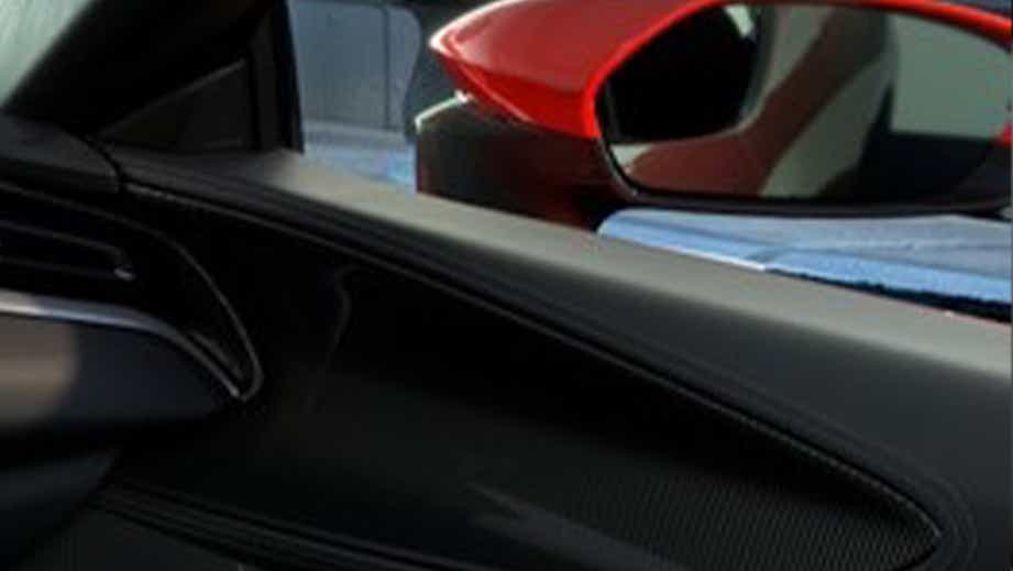 Driver-side door panel and side mirror of a Ferrari SF90 Stradale