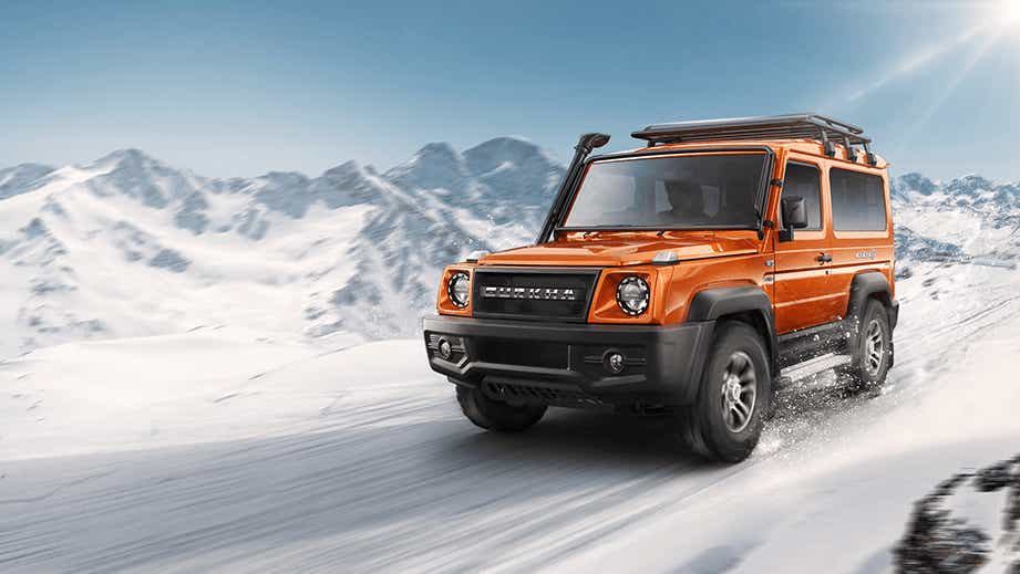 front three-quarter view of a Orange Force Gurkha on a snowy mountain slope