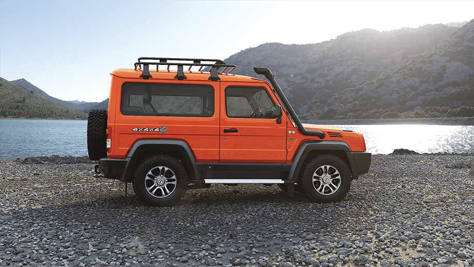 side view of a Orange Force Gurkha by a lakeside