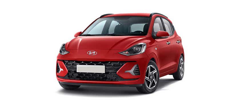 front three-quarter view of a Fiery Red Hyundai Grand i10 Nios