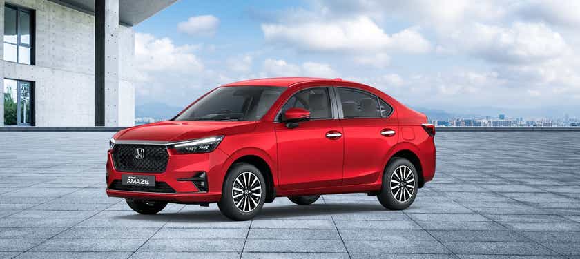 front three-quarter view of a Radiant Red Metallic Honda Amaze