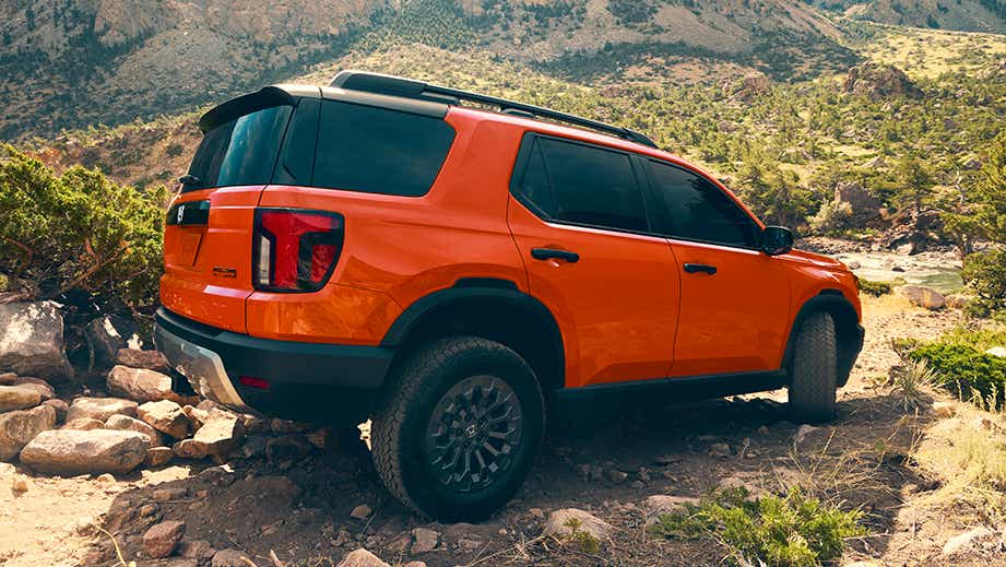 rear three-quarter view of a Honda Passport on a rocky trail