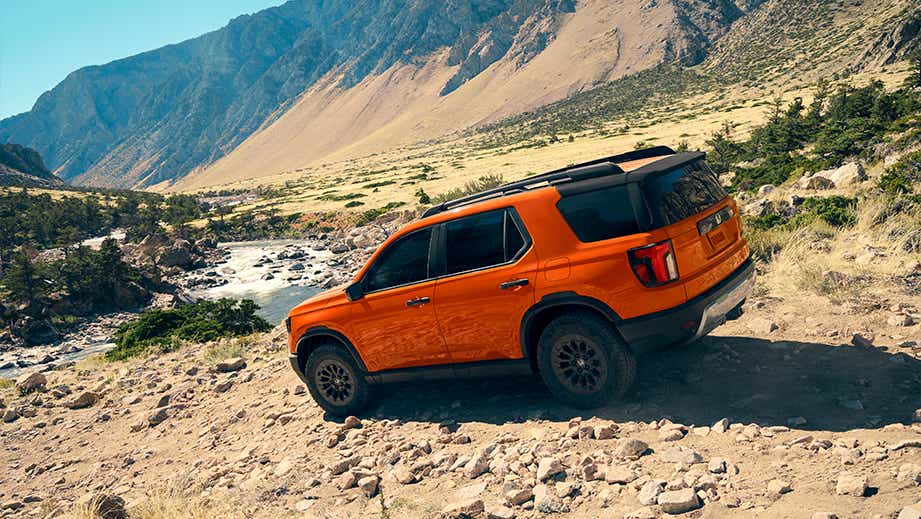 rear three-quarter view of a Honda Passport on a rocky trail