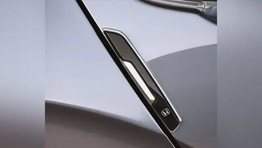 Close-up view of a Honda City Hybrid exterior mirror mount