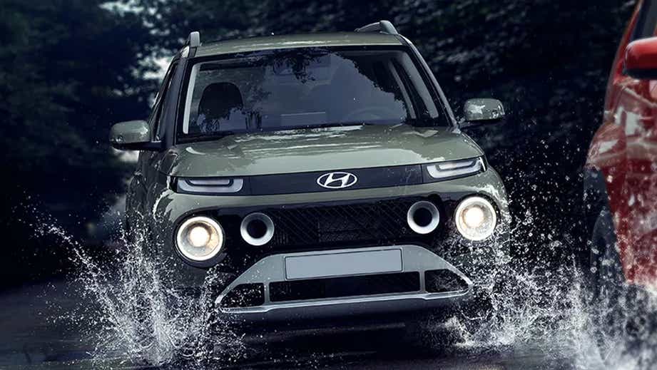 front view of a Hyundai Casper driving through water