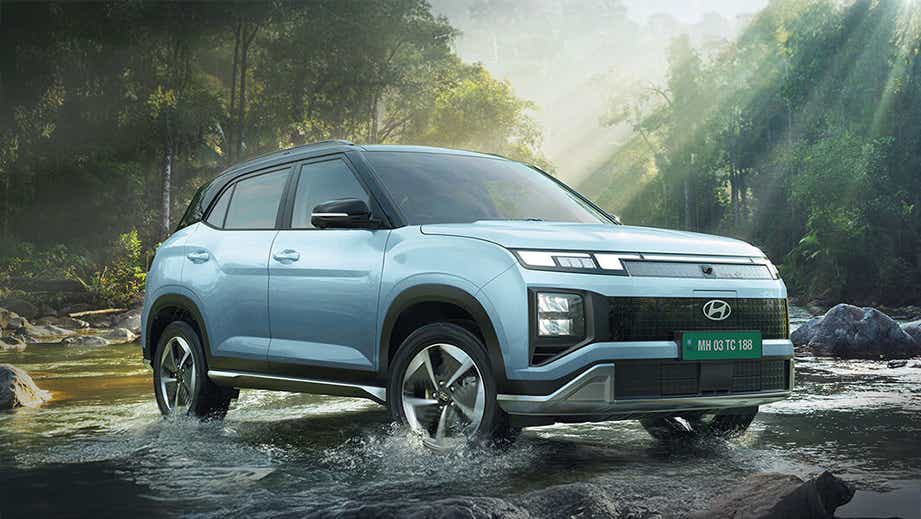 front three-quarter of a Hyundai Creta Electric crossing a stream