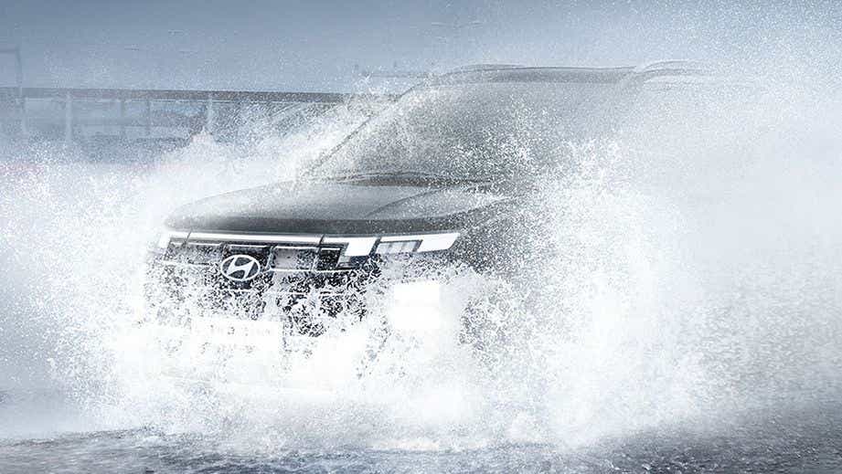 front view of a Hyundai Creta driving through water splash