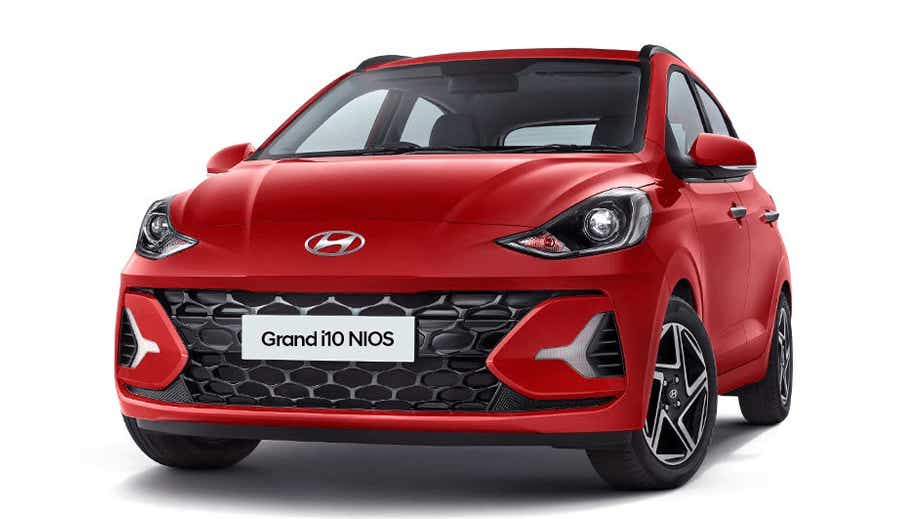 front three-quarter of a Fiery Red Hyundai Grand i10 Nios