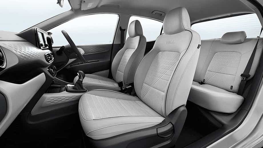 interior dashboard and front seats of a Hyundai Grand i10 Nios