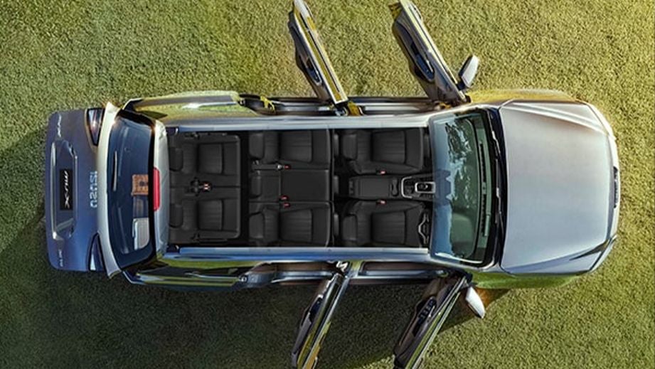 top-down view of a Isuzu MU-X with open doors, showcasing the spacious interior seating arrangement