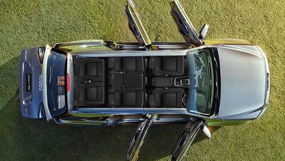 top-down view of a Isuzu MU-X with open doors, showcasing the spacious interior seating arrangement