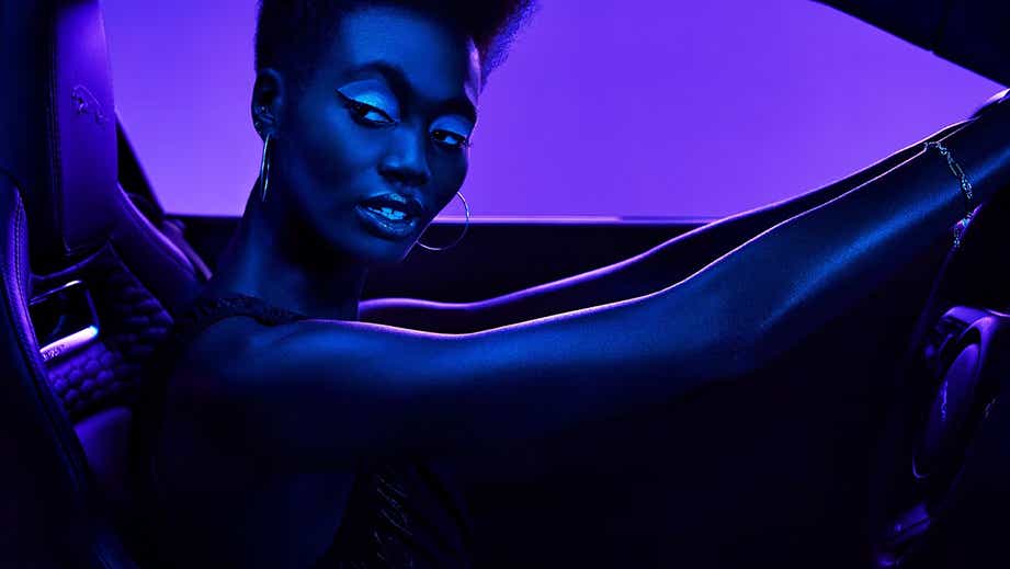 Interior view of a Jaguar F-Type, showcasing the driver in the front seat