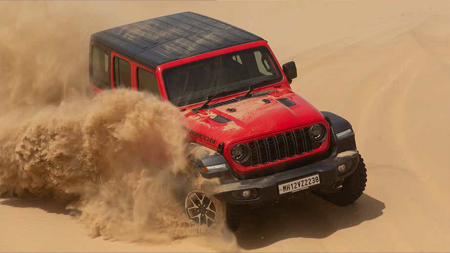 front three-quarter view of a FireCracker Red Jeep Wrangler