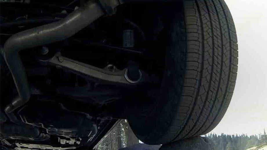 Close-up view of the wheel and undercarriage of a Jeep Compass