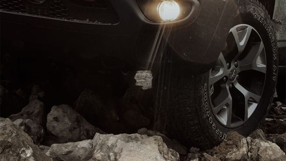 Front wheel and headlight close-up of a Jeep Compass