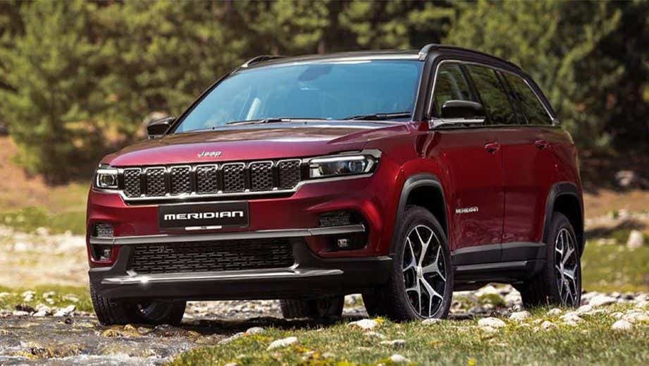 front three-quarter view of a Velvet Red Jeep Meridian 2022-2023