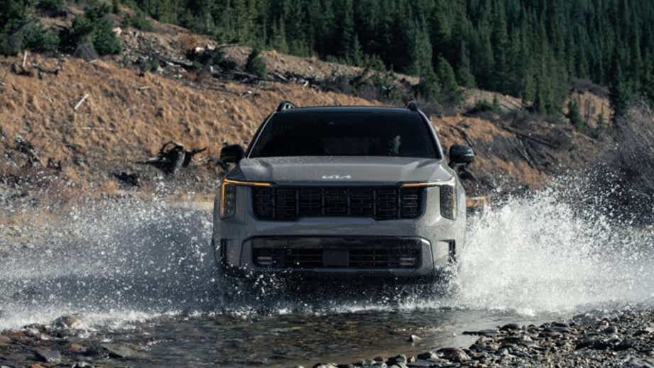 Front view of a Gravity Grey Kia Sorento driving through water