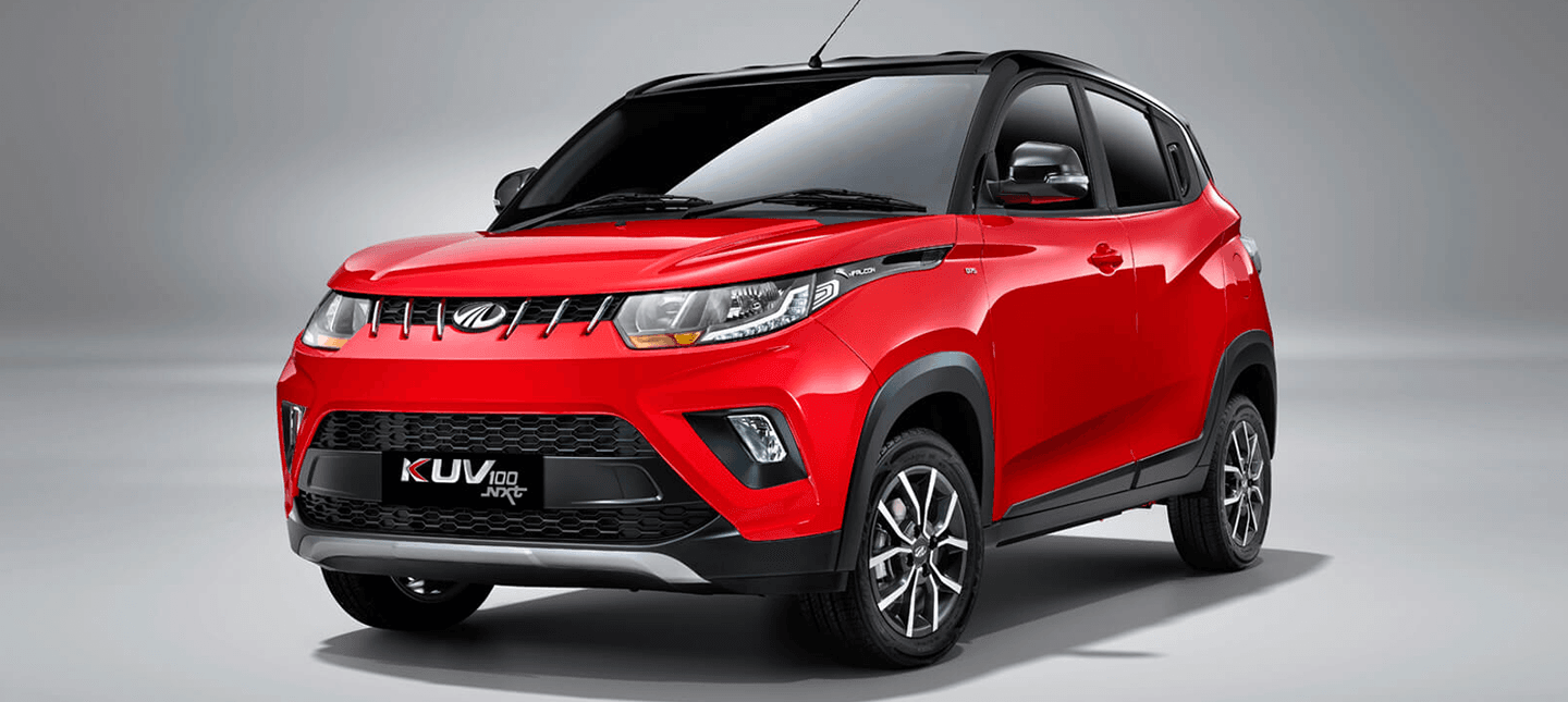 front three-quarter view of a Flamboyant Red Mahindra KUV 100 NXT