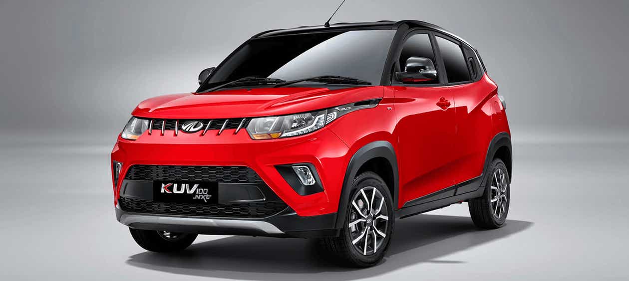 front three-quarter view of a Flamboyant Red Mahindra KUV 100 NXT