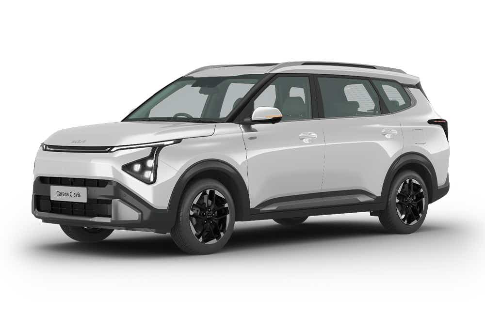 front three-quarter of a Glacier White Pearl Kia Carens Clavis