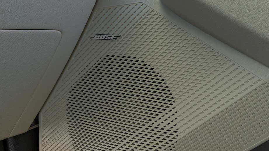 Interior speaker close-up of a Kia Carens Clavis featuring Bose audio system