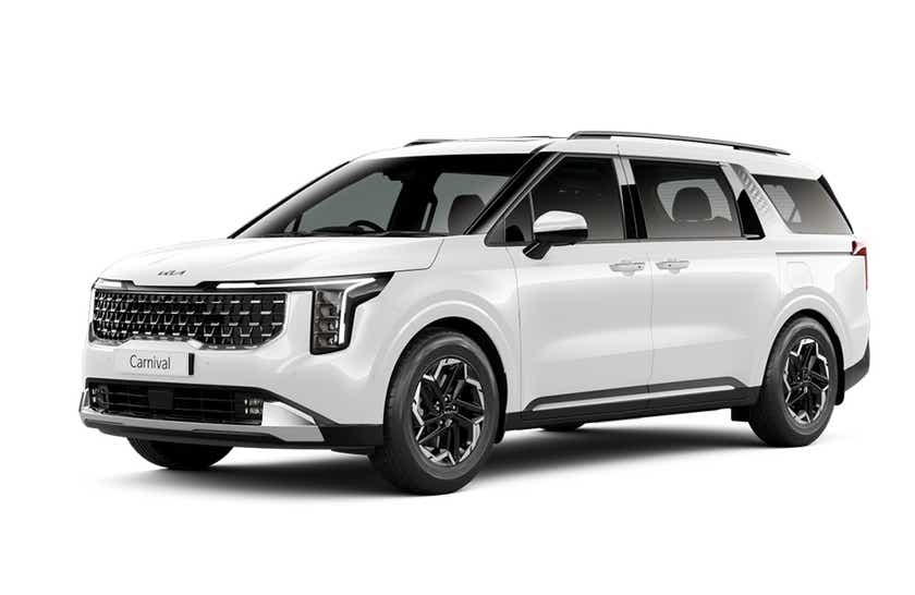 front three-quarter view of a Glacier White Pearl Kia Carnival