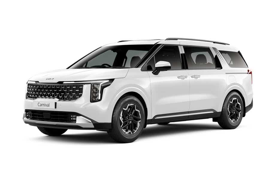 front three-quarter view of a Glacier White Pearl Kia Carnival