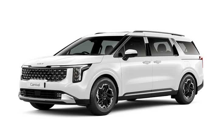 front three-quarter view of a Glacier White Pearl Kia Carnival