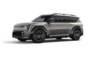 front three-quarter view of a Pebble Gray Kia EV9