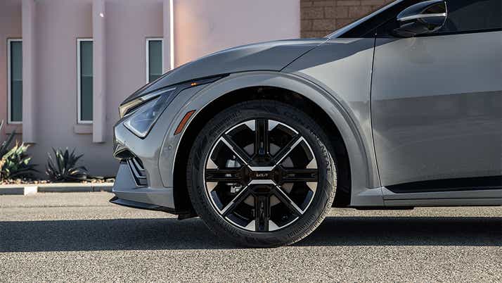 Front wheel and fender view of a Kia EV6