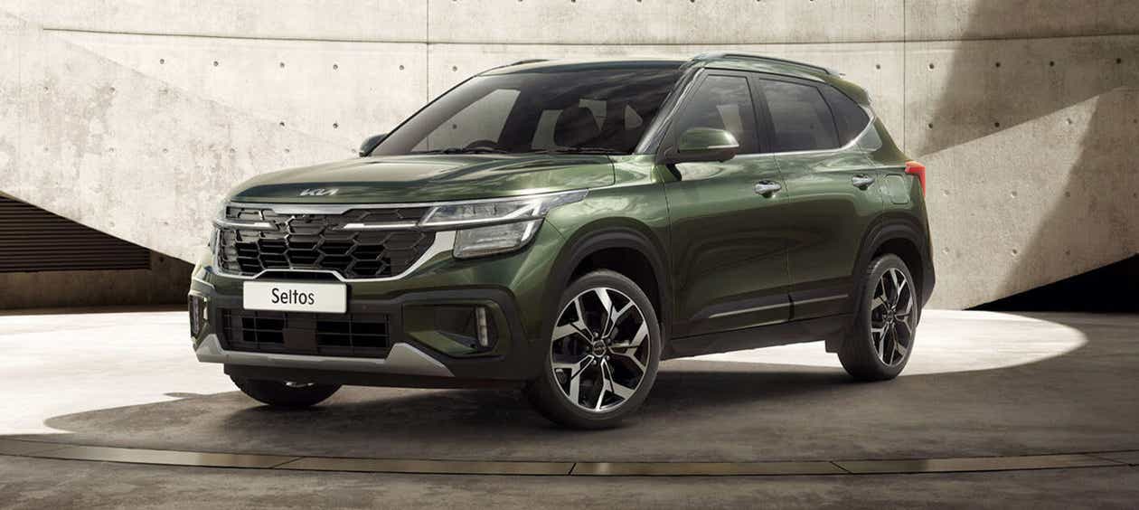 front three-quarter view of a Pewter Olive Kia Seltos