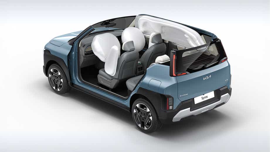 rear three-quarter view of a Kia Syros showing deployed airbags