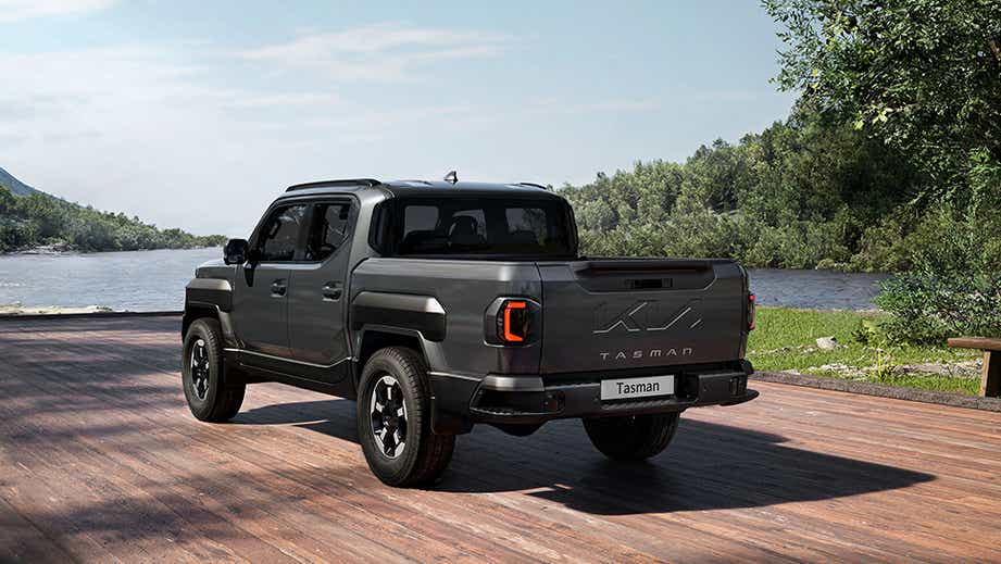 rear three-quarter view of a Magma Grey Kia Tasman