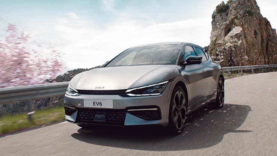 front view of a Kia EV6 2022-2024 driving on a mountain road
