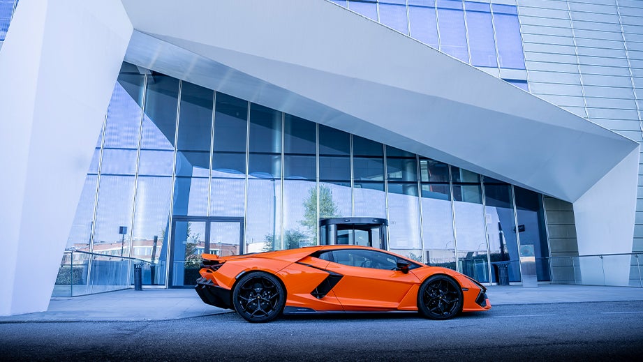 side view of a Lamborghini Revuelto in front of a modern building