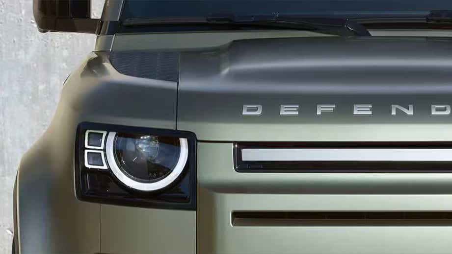 Front view headlight and grille of a Land Rover Defender
