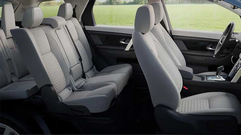 Side interior view of a Land Rover Discovery Sport showing all rows of seats