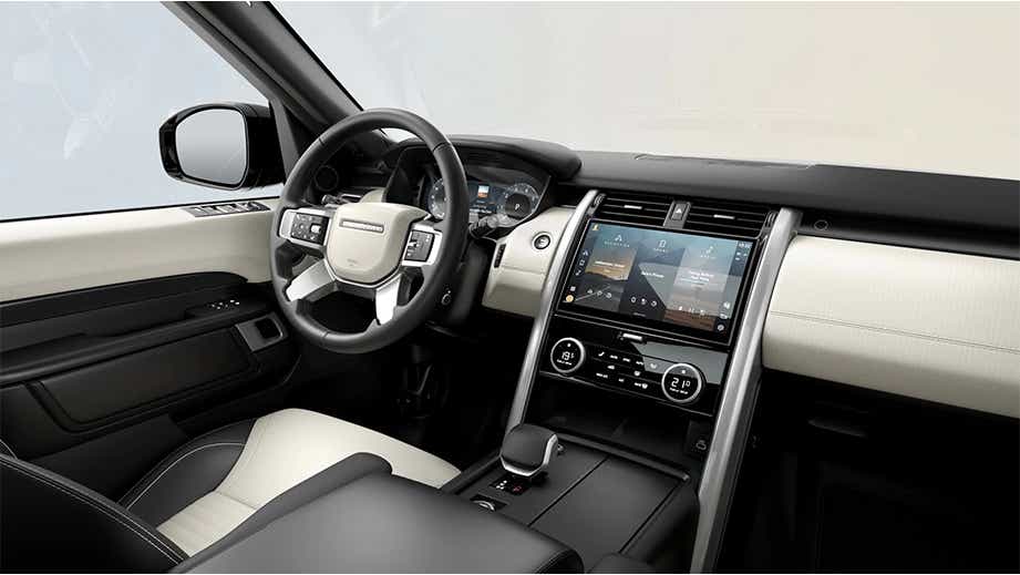 Interior dashboard and steering wheel view of a Land Rover Discovery