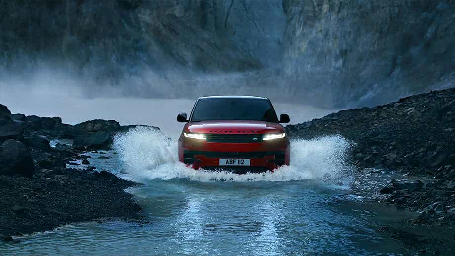 Front view of a Land Rover Range Rover Sport driving through water